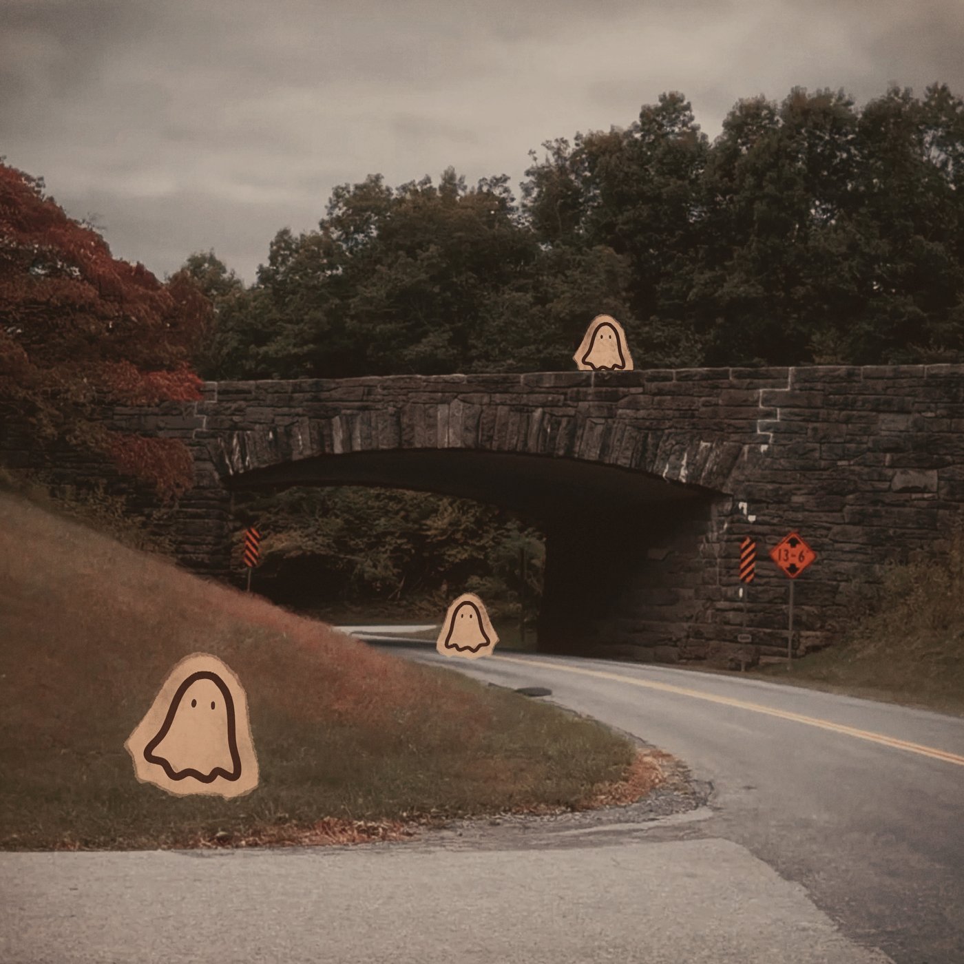 Photo of a stone bridge over a winding road with hand-drawn ghost characters added