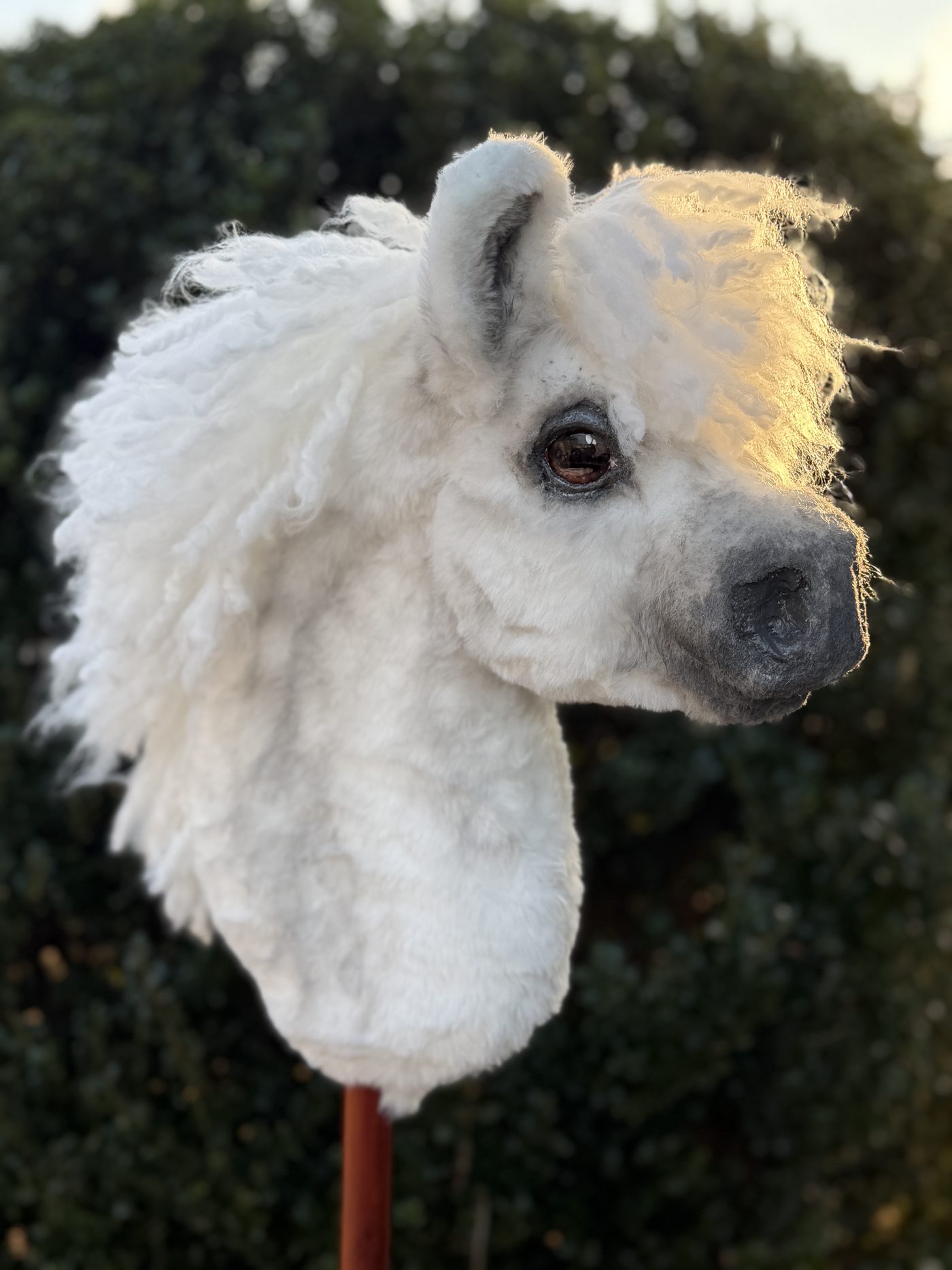 Handmade white hobby horse with a curly mane and glass eyes
