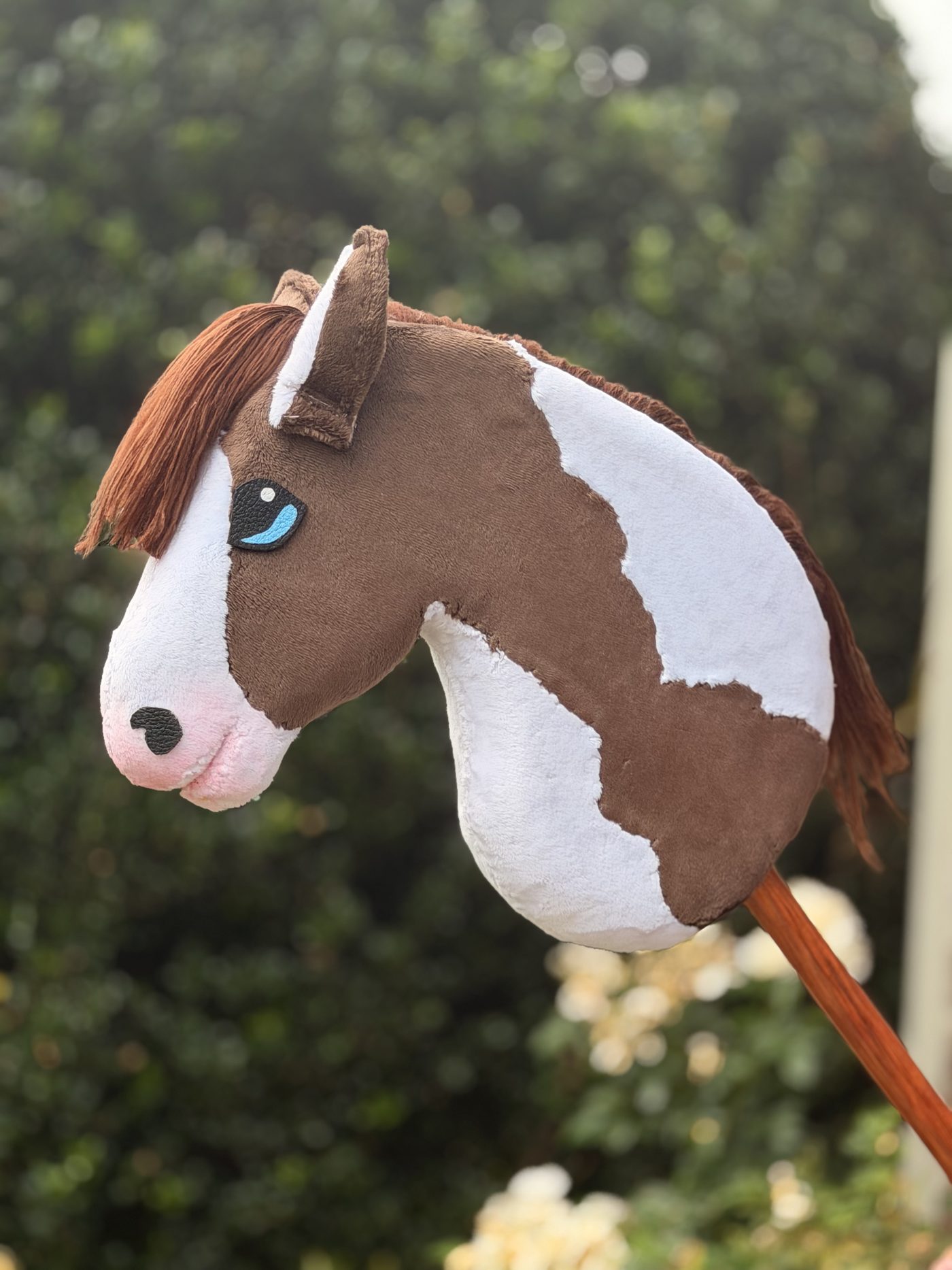 Handmade brown and white paint hobby horse with blue eyes