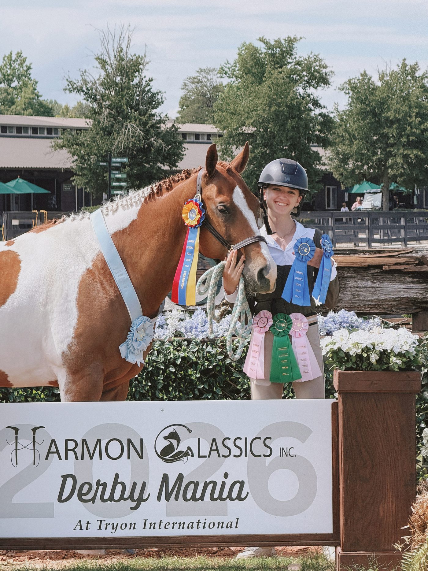 Juliette with her paint pony wearing a champion ribbon and sash at Harmon Classics Derby Mania at Tryon International